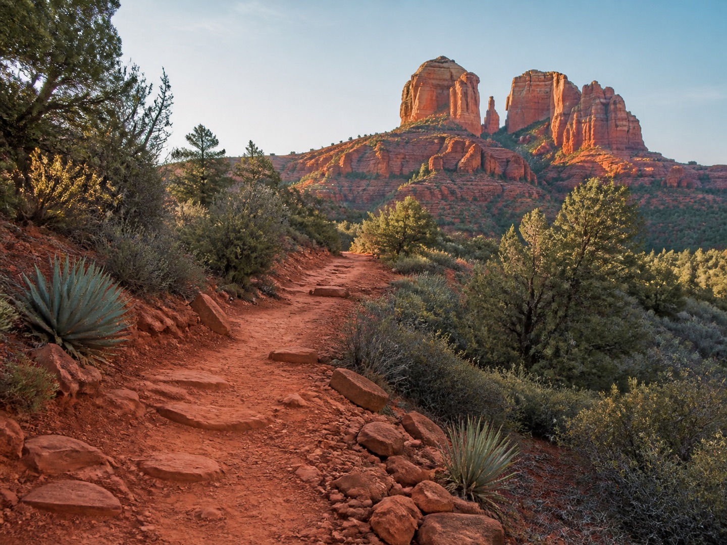 A red-earth trail winding toward Cathedral Rock in Sedona